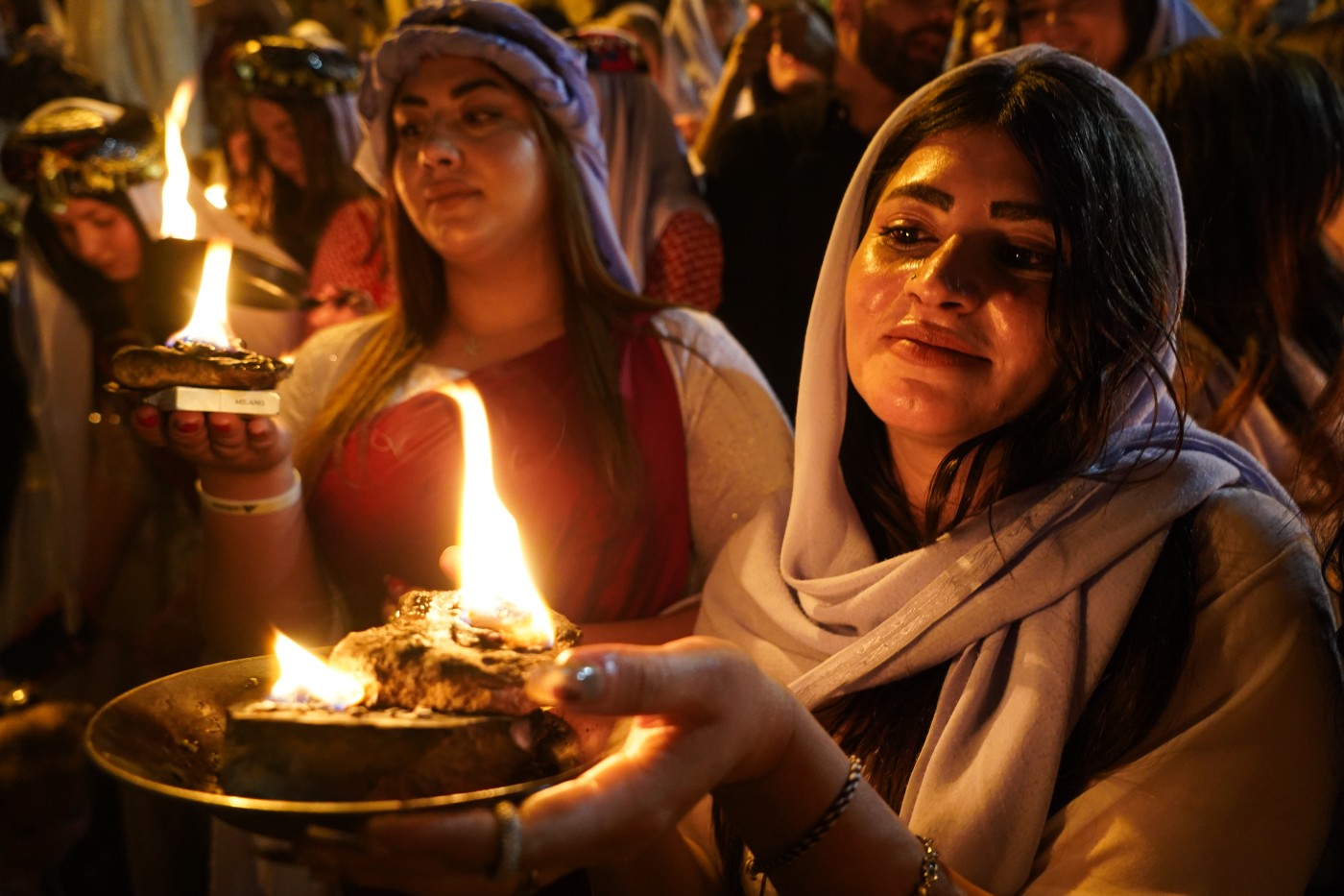 Image of Iraqis Yazidis hold candles at Lalish Temple, in a valley near the northern city of Dohuk